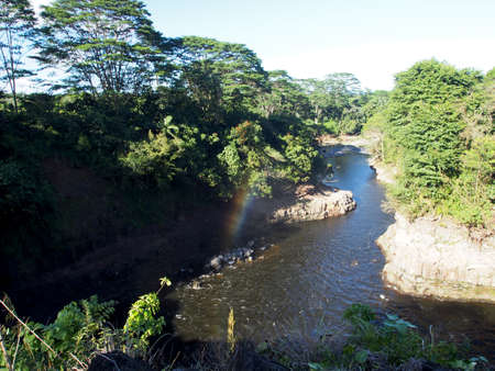Rainbow in âBoiling Pots,â Peâepeâe Falls which is a section of the 18-mile-long Wailuku River on the Big Island of Hawaii. の写真素材