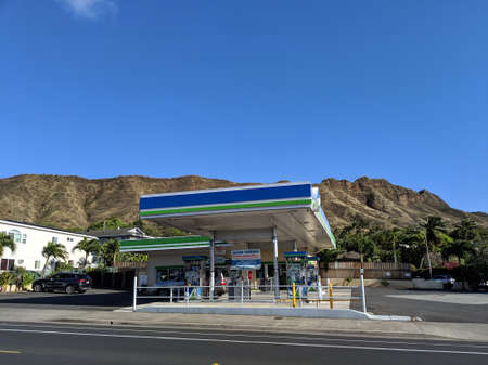 Honolulu - April 18, 2019: Aloha Island Mart Gas station and Diamond Head Crater.