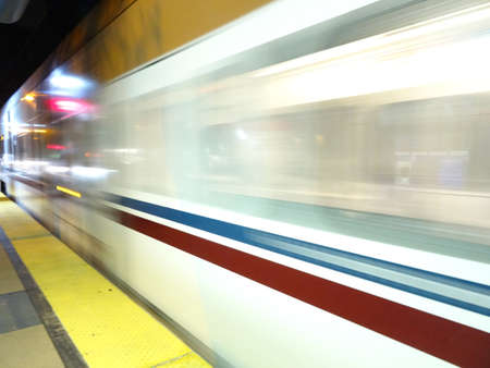 San Jose - March 31, 2015: Blur of VTA transit lightrail train arrives into station at night in San...