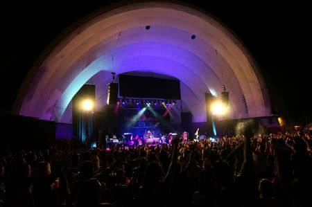 WAIKIKI, OAHU - February 12, 2013:  People wave hands in the air as Band plays on stage at MayJah...