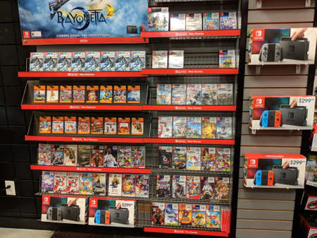 Honolulu - April 7, 2017: Nintendo Switch, Bayonetta 2, and other video game merchandise on display at Gamestop store.のeditorial素材
