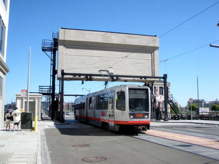 San Francisco - April 18, 2009: T Muni Light-rail train crosses 4th street bridge in Mission Bay.