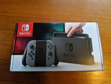 Honolulu - July 22, 2018: Nintendo Switch game machine in box on hardwood floor..