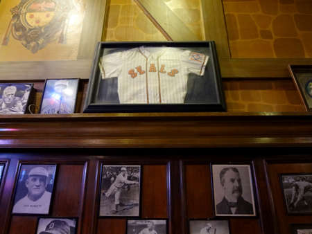 San Francisco - August 30, 2011: Baseball memorabilia on wall display inside bar including photos and San Francisco Seals Jersey in frames.のeditorial素材