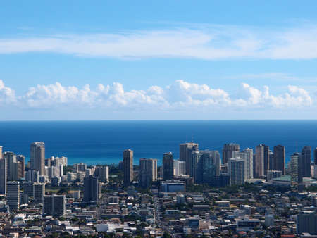 Aerial of Honolulu McCully street leading to Waikiki with  Buildings, parks, hotels, Condos, and Pacific Ocean stretching into the distance on nice day.の写真素材