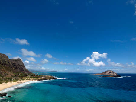Aerial of Waves crash on Makapuu Beach with the Koolau Range Mountains above looking towards Waimanalo Bay on the Windward coast of Oahu, Hawaii.の写真素材