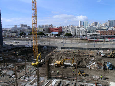San Francisco - February 26, 2008: Construction machines and trucks works at High-rise Construction...