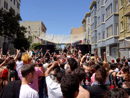 San Francisco - June 25, 2011: Crowd of People dance and party in the street at Lovevolution as DJ spins music.のeditorial素材