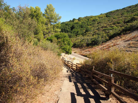 Dirt Path going downward with wood railing in a dry area of Santa Barbara, California.の写真素材