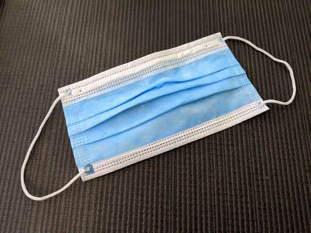 Blue Surgical Face Mask with ear straps on mat.の写真素材