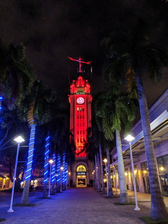 Honolulu - November 21, 2018: Pathway to Aloha Tower at Night which is light up in red and has greeted arriving visitors for a century to Honolulu Harbor on Oahu, Hawaii.  Aloha Tower was the tallest building on the island at the time of its construction.のeditorial素材