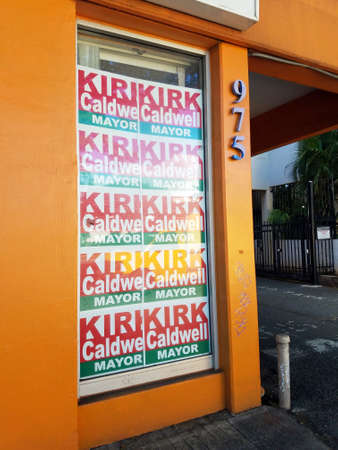Honolulu - December 14, 2016: Kirk Caldwell for Mayor posters in window of orange Building.のeditorial素材