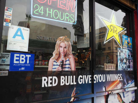 Hollywood, California - October 16, 2019: Britney Spears, Red Bull and Rockstar Poster Ads in window of Convenience store.のeditorial素材