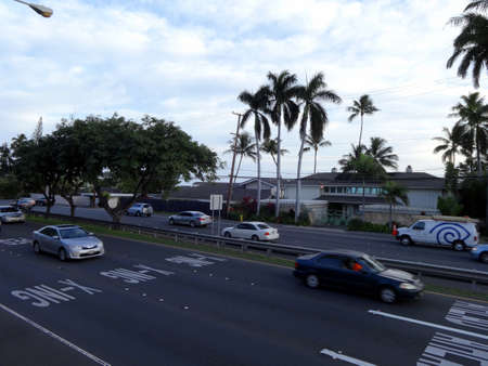Honolulu - December 13, 2013: Cars and Van drive along Kalaniana'ole Highway. during the early evening.のeditorial素材