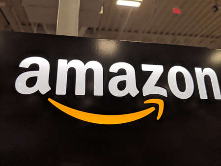 Honolulu - March 16, 2019:  Amazon logo on black shiny wall in Honolulu Best Buy store.  Amazon is an American international electronic commerce company. It is the world's largest online retailer.のeditorial素材