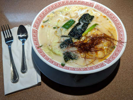 Spice Vegetarian Ramen in bowl with fork and spoon.の写真素材