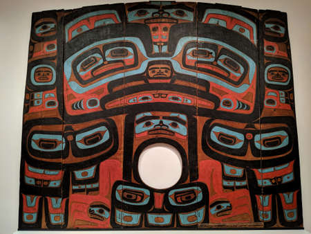 Seattle, Washington - May 16, 2019:  YÃIL X'EENH (RAVEN SCREEN), CA. 1810.  The wooden screen and houseposts adorned with mythical beings sacrd to the clan are the focal point of the longhouse. Functionally, the screen creates a separation for the quarteのeditorial素材