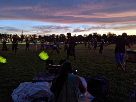 Oahu - July 9, 2021:  DJ Jerome James plays music at people dance outdoors in Kapiolani Park on Oahu, Hawaii.のeditorial素材