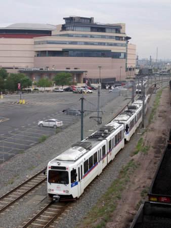 Devner - July 7, 2015: RTD The Ride Electric Trains moves along tracks on cloudy day.のeditorial素材