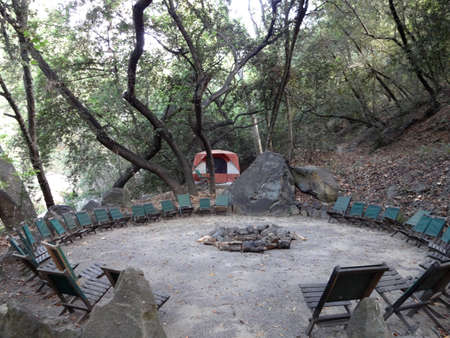 Chair Seats circle Empty Fire pit in the forest of Santa Barbara, California.の写真素材
