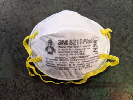 Honolulu - August 1, 2020: White N95 Face Masks with yellow ear straps made by 3M on floor.のeditorial素材