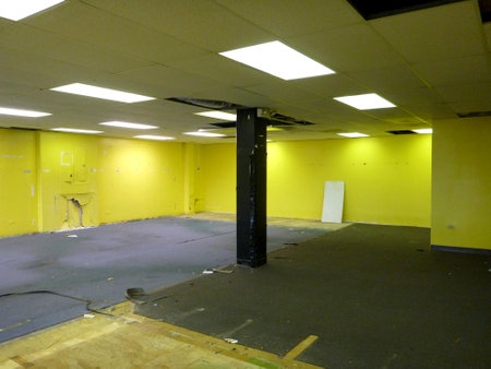 Honolulu - February 24, 2014: Inside ruin down broken commercial space with yellow walls.のeditorial素材