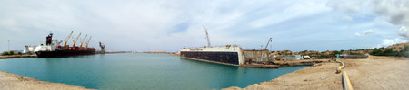 Oahu - May 29, 2009: Barbers Point Harbor with Cargo boat docked at Aloha Marine Lines and Marisco the Shipyard.  Panoramic.の写真素材