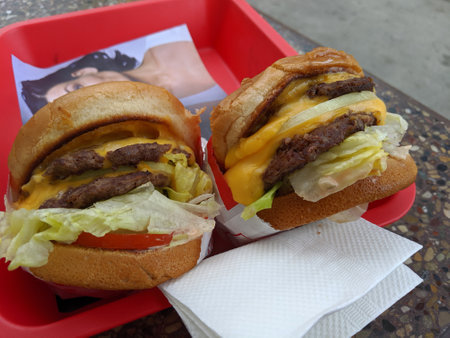 LA, California, United States - October 16, 2019: Two Double-Double Burgers Animal Style at In-N-Out Burger restaurant. In-N-Out Burgers, Inc. is a regional chain of fast food restaurants with locations the United States Southwest.のeditorial素材