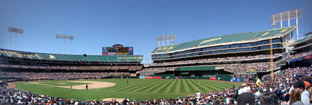 Oakland California - May 23, 2010:  Bay Bridge Series: Giants vs. Oakland A's featuring Baseball players and fans. at Oakland-Alameda County Coliseum.  Panoramic.のeditorial素材