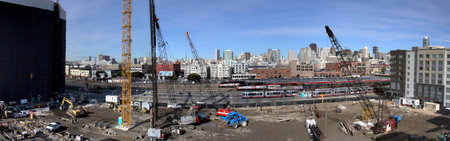 San Francisco - Febuary 6, 2008: Construction machines and people works at High-rise Construction site in San Francisco with Caltrain and great skyline in the distance.のeditorial素材