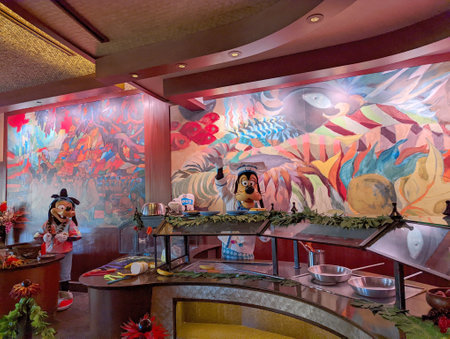 Oahu - Febuary 15, 2022:  Disney Characters Goofy and Max work salad bar at the Aulani Hotel tropical Restaurant.のeditorial素材