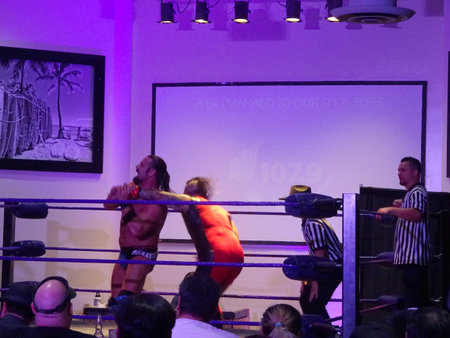 Honolulu - November 17, 2019: Wrestler James Storm twists the arm of Kaimana in the ring at UCE Wrestling event at Dave and Busters in Honolulu, Hawaii.のeditorial素材