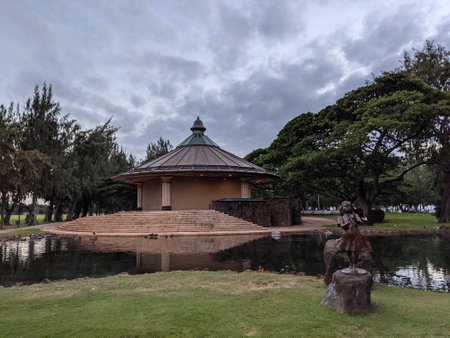 Waikiki - December 13, 2020: Duck in the water of Pond and statue of yound girl surrounded by iron wood trees in Kapiolani Park on Oahu, Hawaiiのeditorial素材
