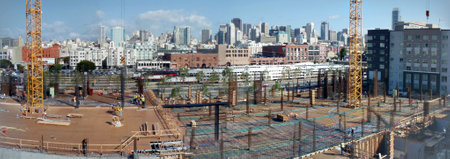 San Francisco - April 29, 2008: Construction machines and people works at High-rise Construction site in San Francisco with Caltrain and great skyline in the distance.のeditorial素材