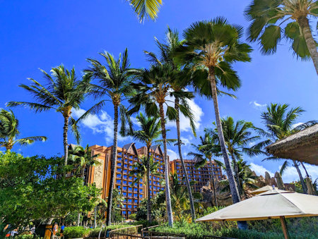 Oahu - August 8, 2023: Disney Aulani tropical hotel surrounded by palm trees.のeditorial素材