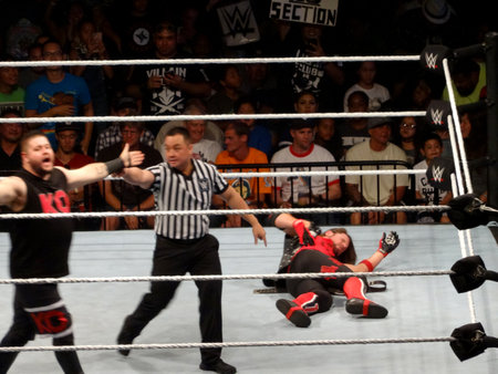 Honolulu - September 13, 2017:  Kevin Owens holds arms open as AJ Styles lays on the ground before start of championship match at live event.のeditorial素材