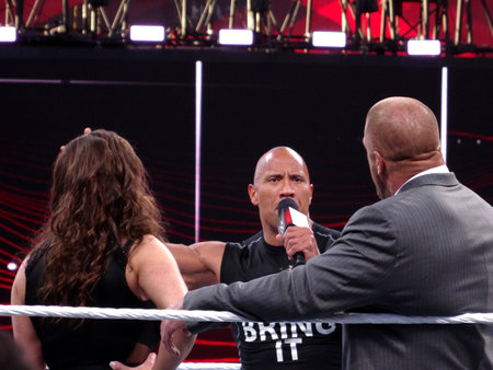 Santa Clara, California - March 29, 2015: International superstar the Rock, Dwayne Johnson stands in the ring and yells into mic at Triple H and Stephanie McMahon during Wrestlemania 31 at the Levi's Stadium.のeditorial素材