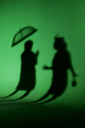 two women in silhouette on a green background cyclo studio