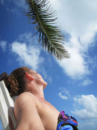 Young Woman Sunbathing on the Beach                               