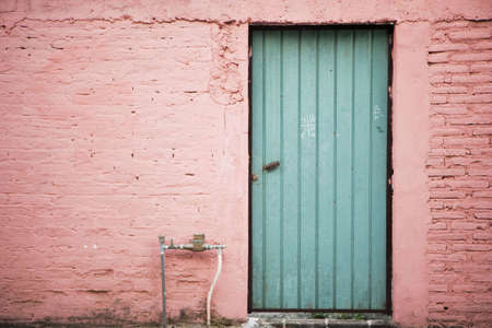 Teal Wooden Door and Pink Wallの写真素材