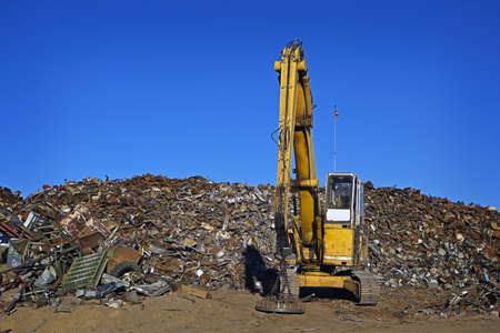 Yellow Crane and Giant Pile of Scrap Metalの写真素材