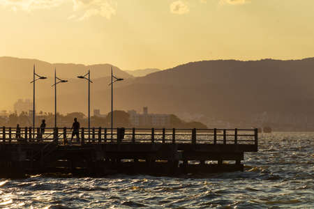 People on the deck at sunset in Florianopolis, Santa Catarina, Brazil.