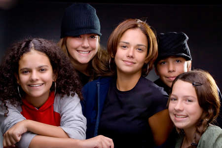 Group of stylish teenagers posing in studio, black background,の写真素材