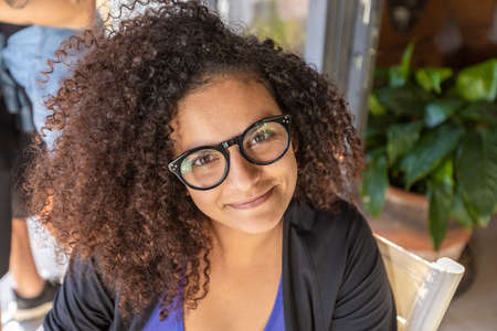 beautiful african american girl with glasses smiling,