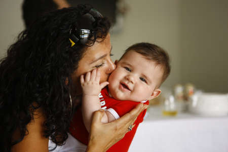 mother kisses and hugs her beautiful son, narrow focus