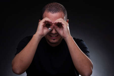man posing for camera, shaved hair, italian ethnicity, black shirt, studio light, neutral background