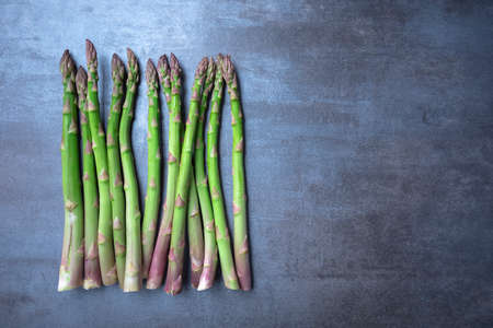 fresh green asparagus. Healthy eating concept. Food for vegetarians. Raw vegetables. Dark background. Free space for edits.の写真素材