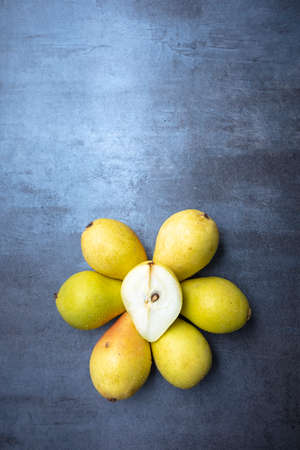 ripe pears on gray background, view from above, free space for edits
