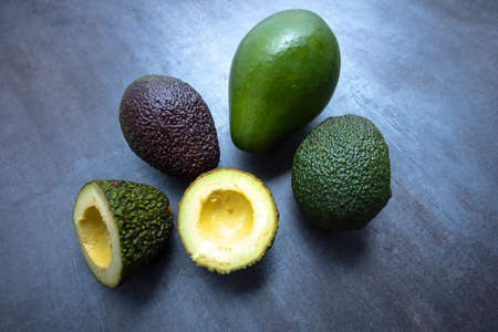 Fresh avocado on gray base, seen from above.