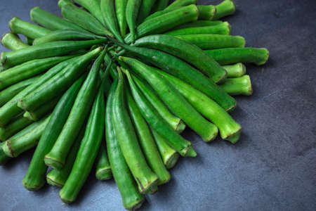 Fresh okra, lady finger, on gray table.の写真素材